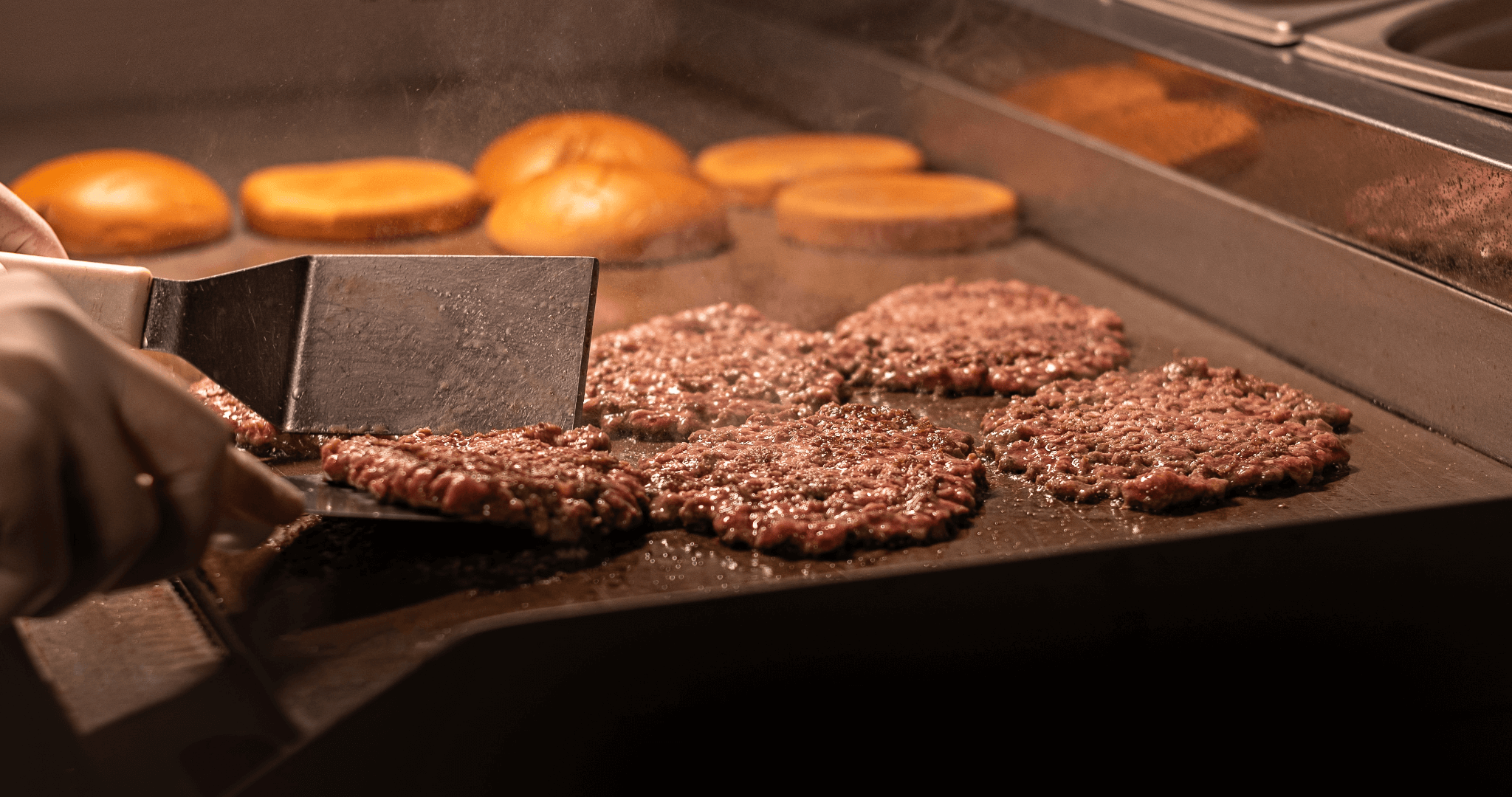 smash burgers on the grill