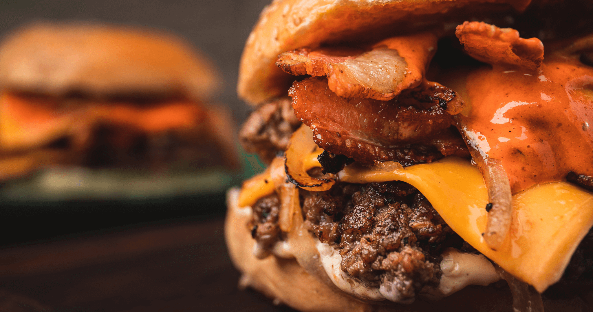 a smash burger with cheese and bacon ready to eat