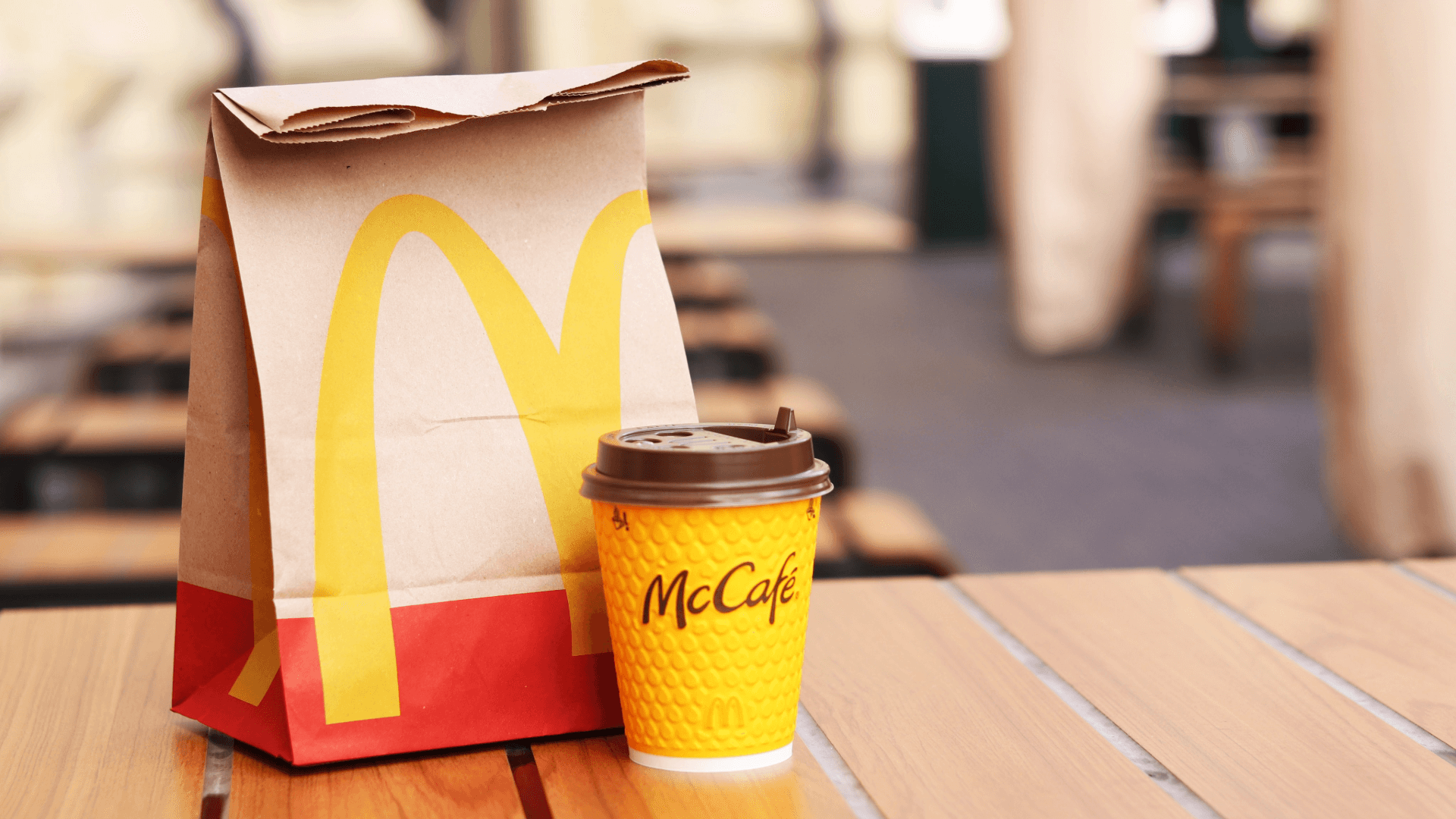 McDonalds coffee and bag on table